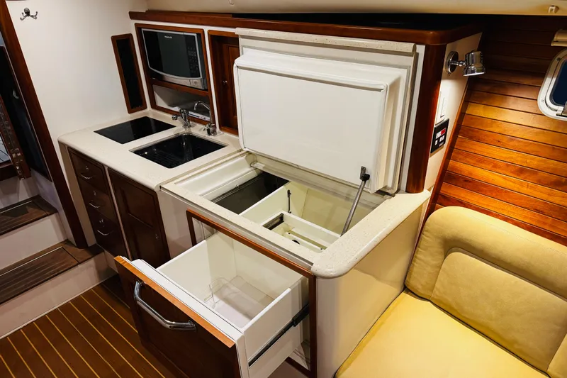 By The Way Yacht Photos Pics 2015 MJM 36z Express yacht interior with modern kitchen and wooden accents.