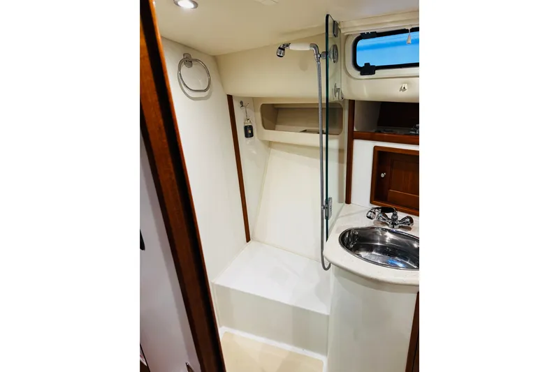 By The Way Yacht Photos Pics 2015 MJM 36z Express yacht bathroom with shower, sink, and wooden cabinetry.