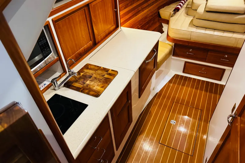 By The Way Yacht Photos Pics Luxurious interior of 2015 MJM 36z Express yacht with wooden cabinetry and modern amenities.