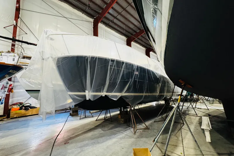 By The Way Yacht Photos Pics 2015 MJM 36z Express yacht covered in plastic, stored indoors.