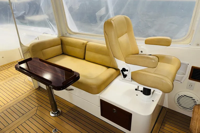 By The Way Yacht Photos Pics Interior of 2015 MJM 36z Express with tan seating and wooden table.