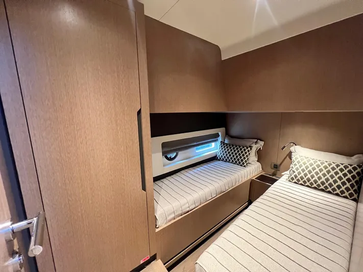  Yacht Photos Pics 2024 Sirena 48 Flybridge cabin with twin beds and modern wood finish.