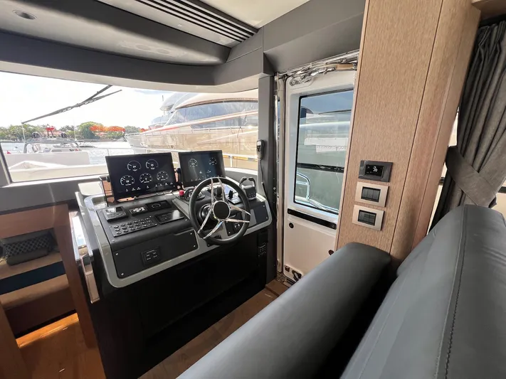  Yacht Photos Pics 2024 Sirena 48 Flybridge helm with modern controls and panoramic view.