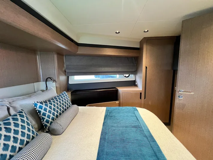  Yacht Photos Pics Luxurious cabin interior of 2024 Sirena 48 Flybridge yacht with elegant bedding and wood finishes.