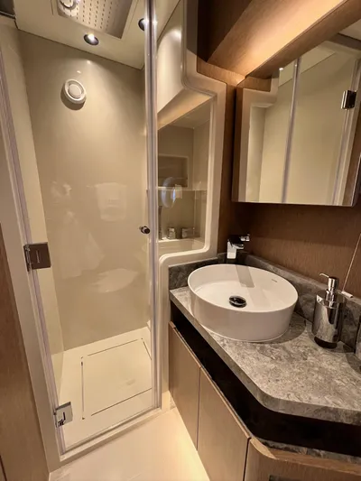  Yacht Photos Pics Luxurious bathroom in 2024 Sirena 48 Flybridge yacht with modern fixtures and elegant design.