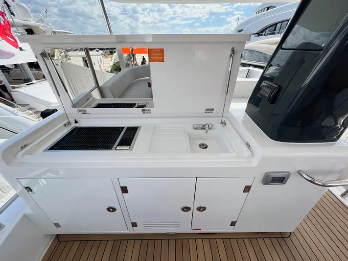  Yacht Photos Pics Outdoor kitchen on 2024 Sirena 48 Flybridge yacht with grill and sink.
