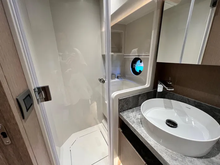  Yacht Photos Pics Modern bathroom in 2024 Sirena 48 Flybridge yacht with sleek sink and shower.