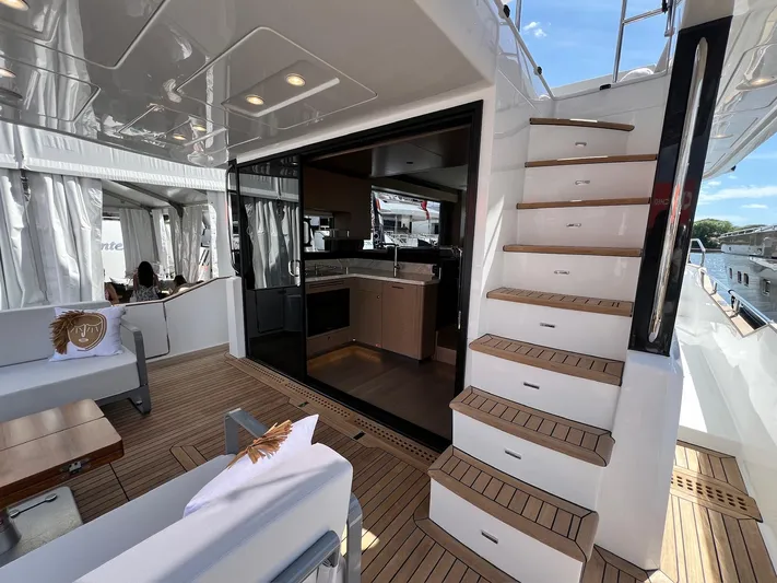  Yacht Photos Pics 2024 Sirena 48 Flybridge yacht interior with modern kitchen and elegant staircase.