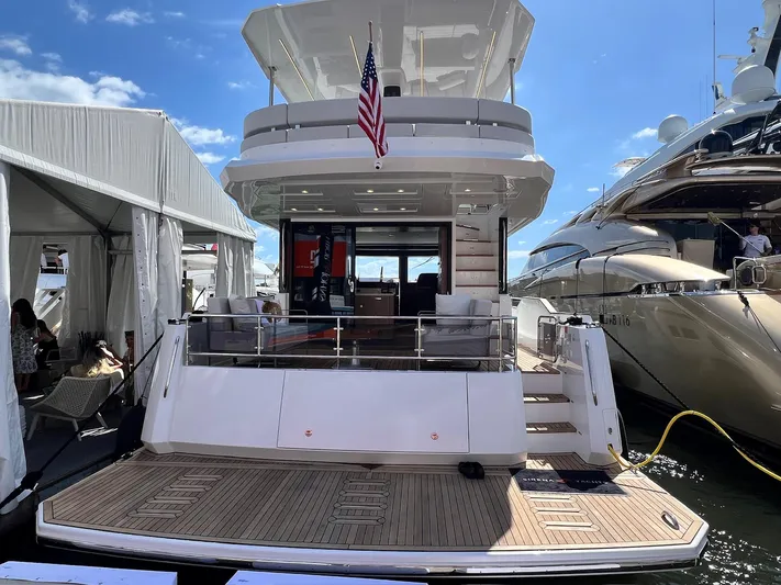  Yacht Photos Pics 2024 Sirena 48 Flybridge yacht docked, showcasing elegant design and spacious deck.