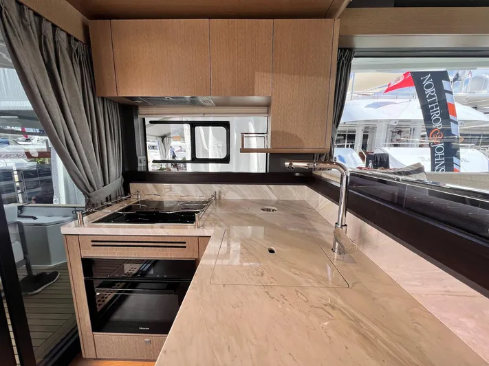  Yacht Photos Pics Modern kitchen interior on 2024 Sirena 48 Flybridge yacht, featuring sleek countertops and appliances.