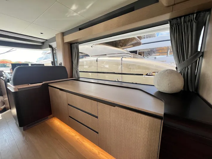  Yacht Photos Pics Luxurious interior of 2024 Sirena 48 Flybridge yacht with modern wood cabinetry.