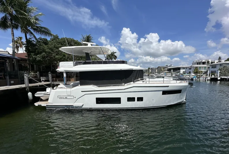  Yacht Photos Pics 2024 Sirena 48 Flybridge yacht docked in a sunny marina setting.