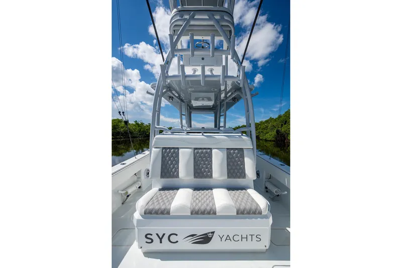 Final/final Yacht Photos Pics 2025 Invincible 33 Catamaran with luxurious seating and sleek design under a clear sky.