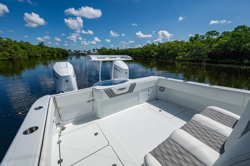 Final/final Yacht Photos Pics 2025 Invincible 33 Catamaran on serene waterway, featuring sleek design and dual outboard engines.