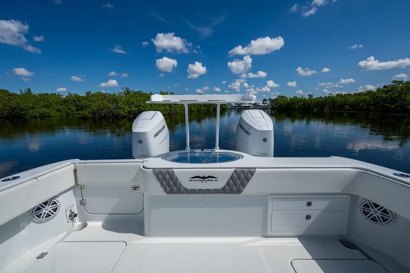 Final/final Yacht Photos Pics 2025 Invincible 33 Catamaran on serene water, featuring dual Mercury engines.