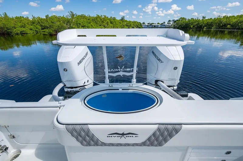 Final/final Yacht Photos Pics 2025 Invincible 33 Catamaran with dual Mercury engines on a serene water backdrop.