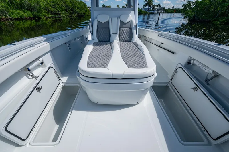 Final/final Yacht Photos Pics 2025 Invincible 33 Catamaran interior with cushioned seating and storage compartments.