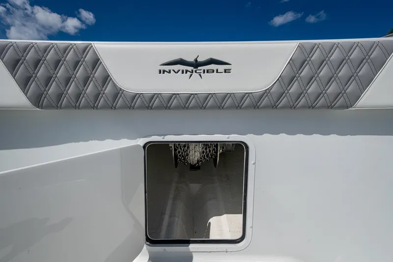 Final/final Yacht Photos Pics 2025 Invincible 33 Catamaran interior detail with logo and quilted upholstery.