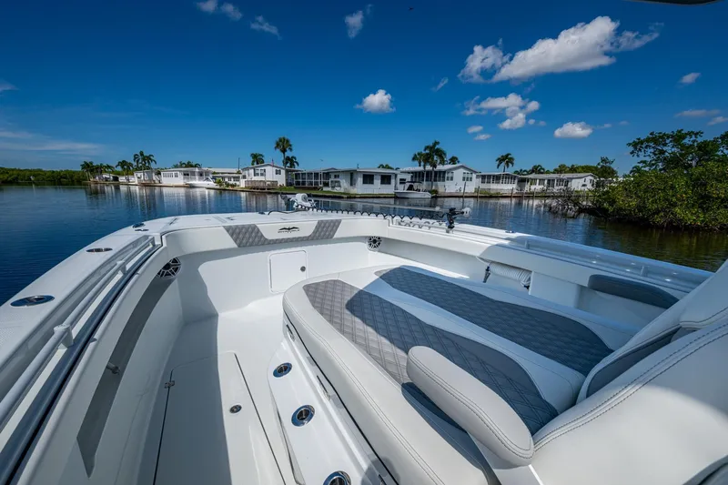 Final/final Yacht Photos Pics 2025 Invincible 33 Catamaran on calm water, showcasing luxurious seating and modern design.