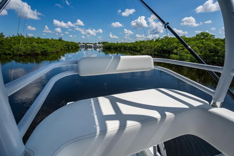 Final/final Yacht Photos Pics Invincible 33 Catamaran 2025 on serene waterway with lush greenery and blue sky.