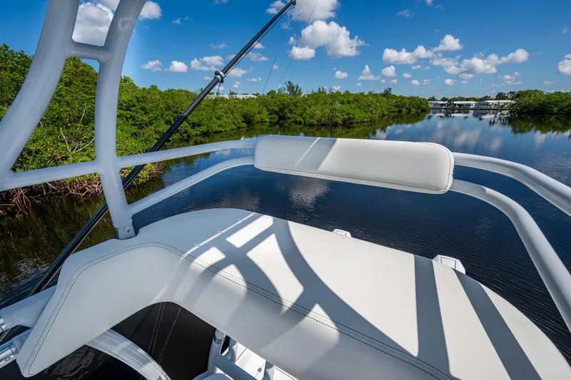 Final/final Yacht Photos Pics Invincible 33 Catamaran 2025 on serene waterway, surrounded by lush greenery and blue sky.