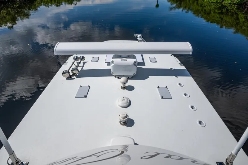 Final/final Yacht Photos Pics 2025 Invincible 33 Catamaran deck view on calm water, showcasing sleek design and equipment.