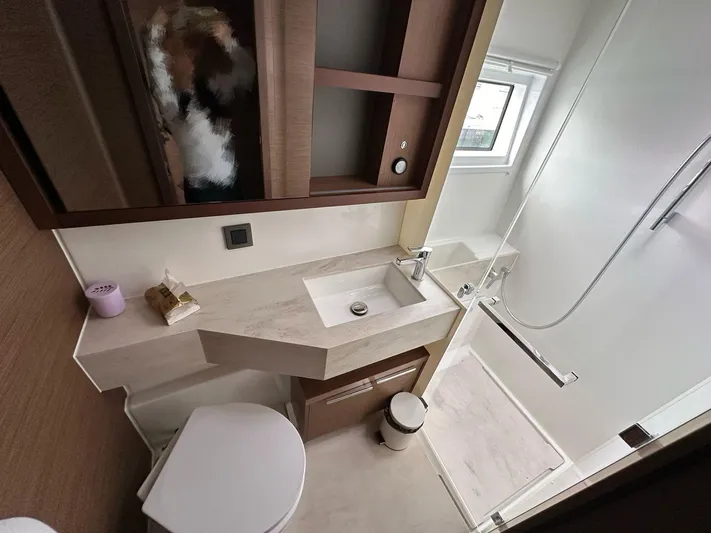  Yacht Photos Pics Modern bathroom in a 2021 Lagoon 46 yacht with shower and sleek fixtures.