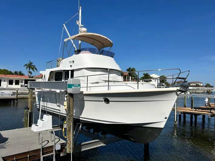 Good Timimg Yacht Photos Pics 2015 Beneteau Swift Trawler 34 docked, showcasing sleek design and spacious deck.