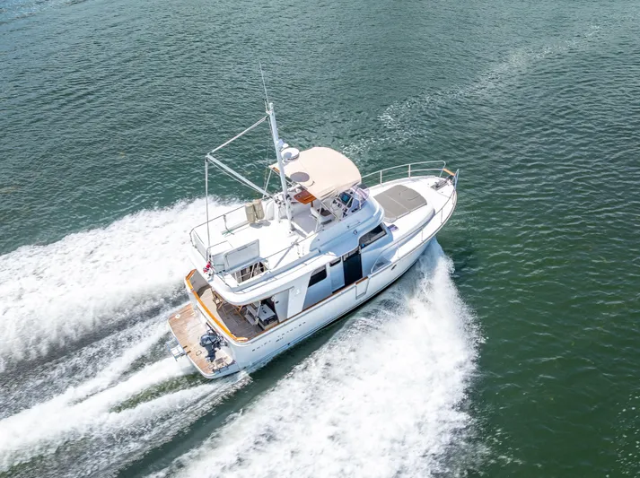 Good Timimg Yacht Photos Pics 2015 Beneteau Swift Trawler 34 cruising on open water, aerial view.
