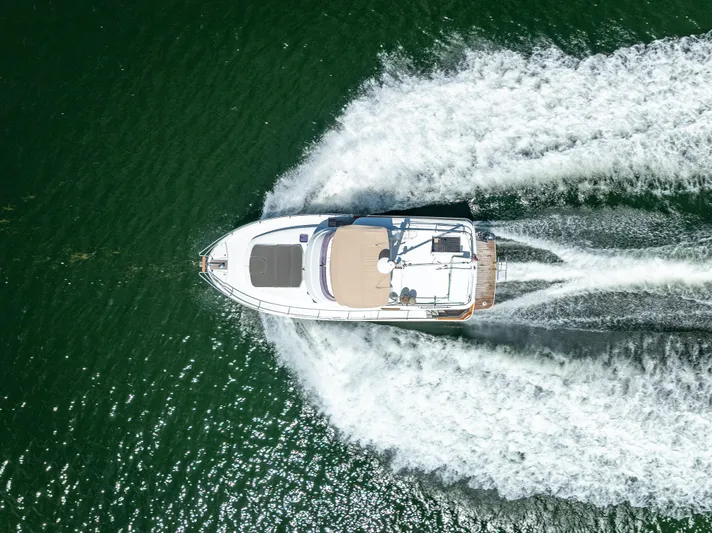 Good Timimg Yacht Photos Pics Aerial view of 2015 Beneteau Swift Trawler 34 cruising on open water.