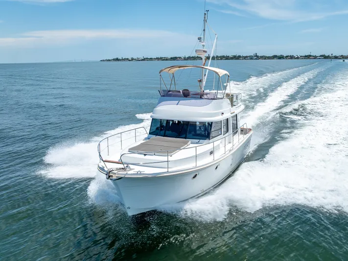 Good Timimg Yacht Photos Pics 2015 Beneteau Swift Trawler 34 cruising on open water, showcasing sleek design and performance.