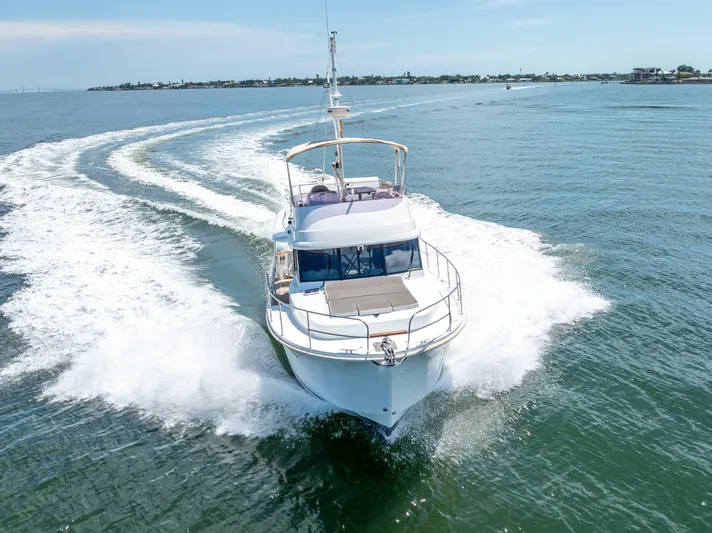 Good Timimg Yacht Photos Pics 2015 Beneteau Swift Trawler 34 cruising on open water, creating a dynamic wake.