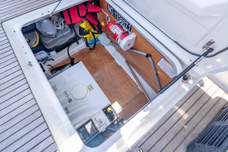 Good Timimg Yacht Photos Pics Open storage compartment on 2015 Beneteau Swift Trawler 34, showing equipment and safety gear.