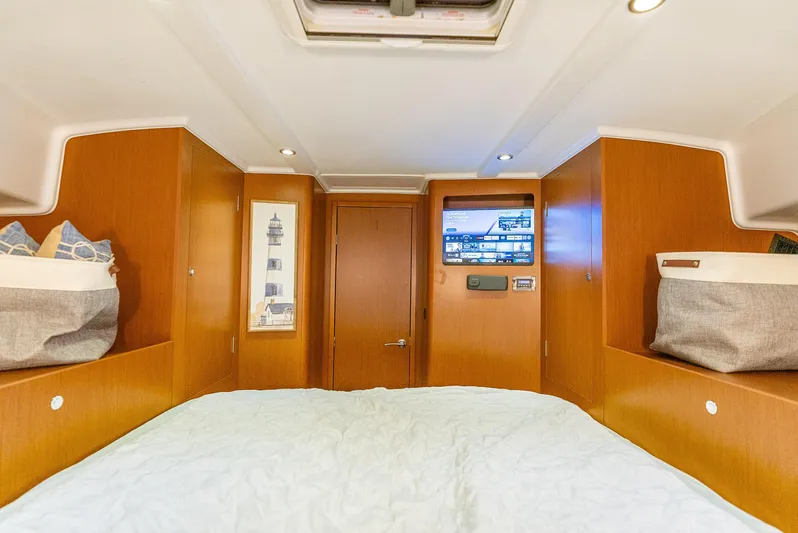 Good Timimg Yacht Photos Pics 2015 Beneteau Swift Trawler 34 cabin interior with wood paneling and cozy bedding.