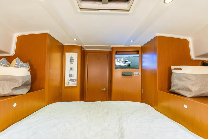 Good Timimg Yacht Photos Pics 2015 Beneteau Swift Trawler 34 cabin interior with wood paneling and cozy bedding.