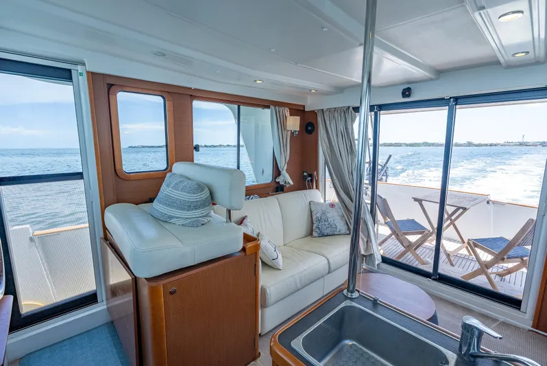 Good Timimg Yacht Photos Pics Interior of 2015 Beneteau Swift Trawler 34 with ocean view and comfortable seating.