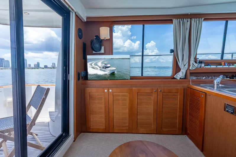 Good Timimg Yacht Photos Pics Interior of 2015 Beneteau Swift Trawler 34 with wooden cabinetry and ocean view.