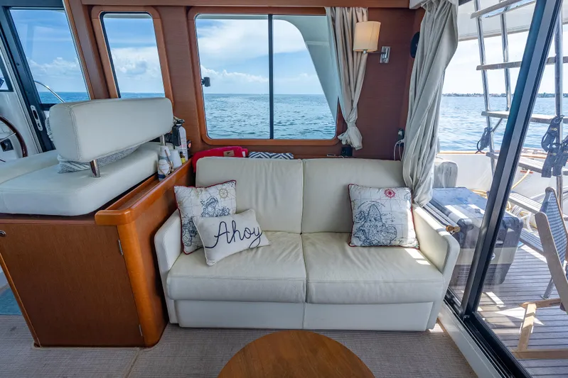 Good Timimg Yacht Photos Pics Interior of 2015 Beneteau Swift Trawler 34 with cozy seating and ocean view.