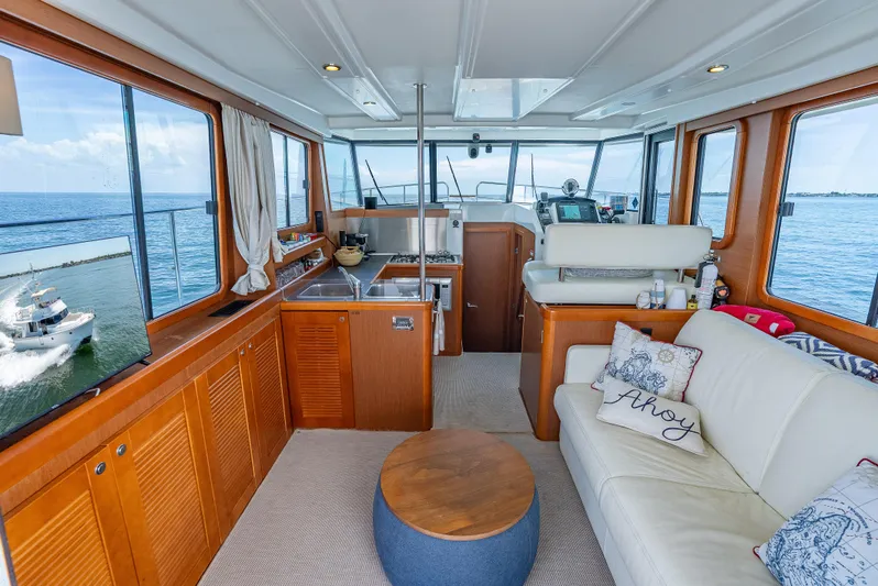 Good Timimg Yacht Photos Pics Interior of 2015 Beneteau Swift Trawler 34 with kitchen, seating, and ocean view.