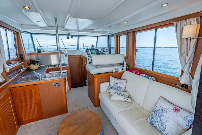 Good Timimg Yacht Photos Pics Interior of 2015 Beneteau Swift Trawler 34 with cozy seating and ocean view.
