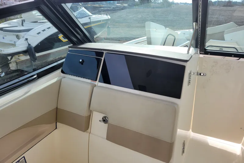  Yacht Photos Pics 2023 Boston Whaler 280 Vantage interior with beige seating and storage compartment.
