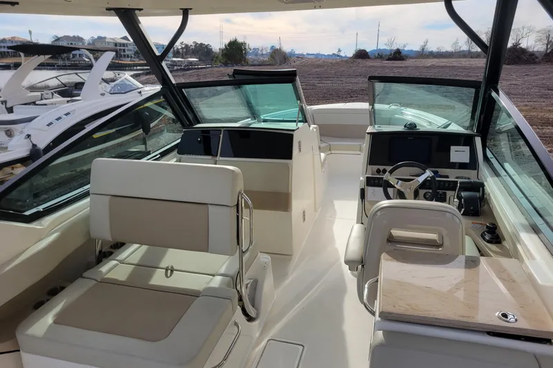  Yacht Photos Pics 2023 Boston Whaler 280 Vantage boat interior with helm and seating area.