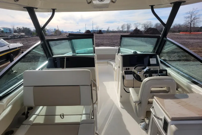 Yacht Photos Pics 2023 Boston Whaler 280 Vantage boat interior with helm and seating area.