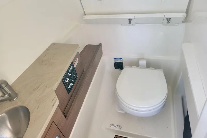  Yacht Photos Pics 2023 Boston Whaler 280 Vantage boat bathroom with toilet and sink.
