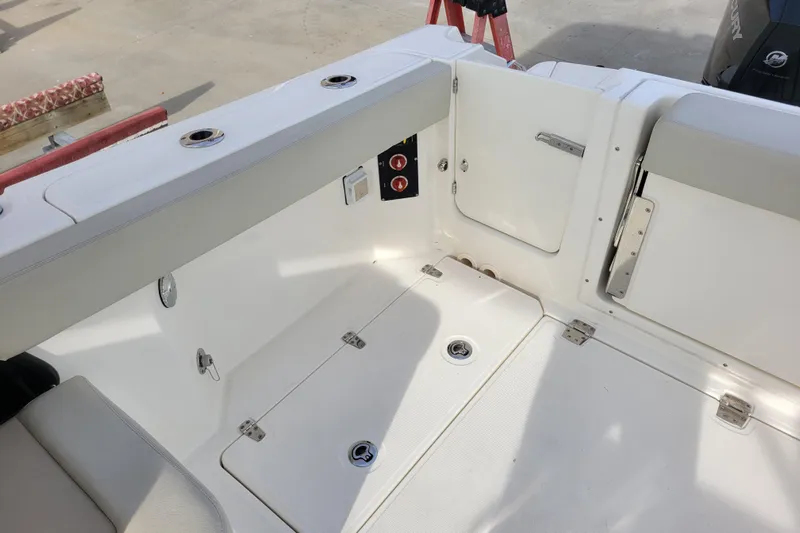  Yacht Photos Pics 2023 Boston Whaler 280 Vantage boat interior, featuring seating and storage compartments.