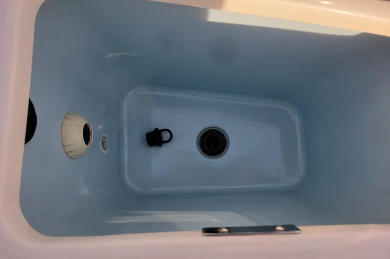  Yacht Photos Pics Livewell interior of 2023 Boston Whaler 280 Vantage boat, featuring drain and plug.