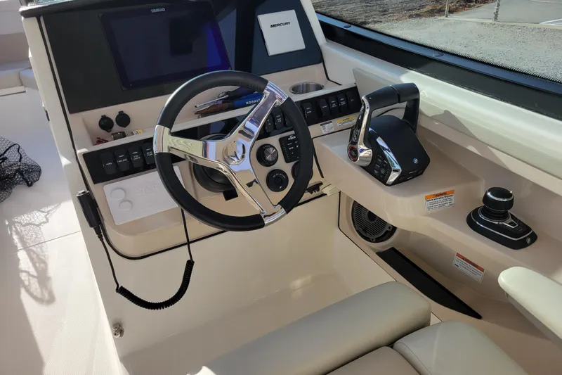  Yacht Photos Pics 2023 Boston Whaler 280 Vantage helm with steering wheel and control panel.
