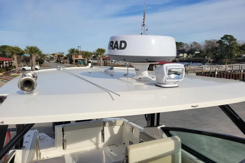  Yacht Photos Pics 2023 Boston Whaler 280 Vantage boat with radar and spotlight on deck.
