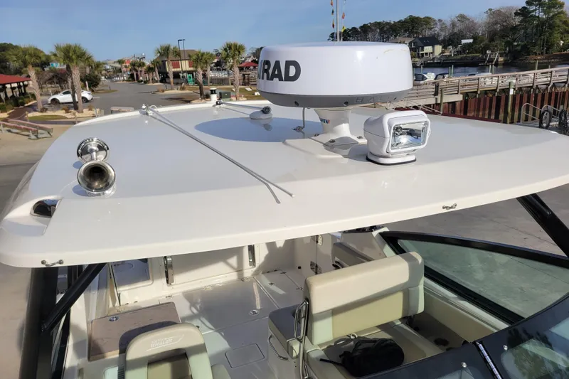  Yacht Photos Pics 2023 Boston Whaler 280 Vantage boat with radar and spotlight on deck.