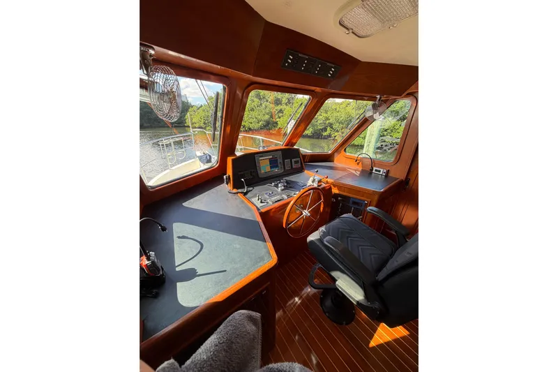 Angels Envy Yacht Photos Pics Pilothouse of 2006 North Pacific 42 yacht with wooden interior and navigation equipment.